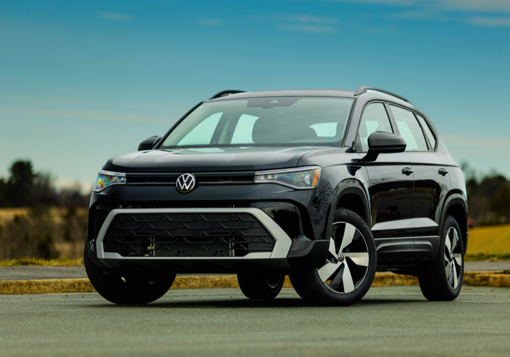2025 Volkswagen Taos parked on a paved surface with trees in the background.