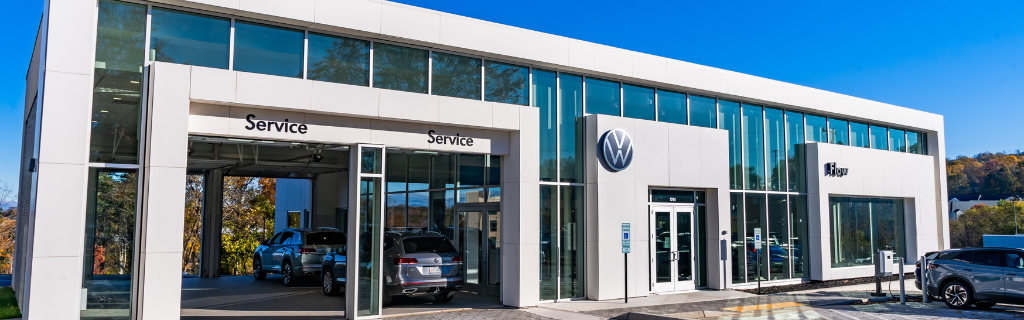 Flow Volkswagen of Charlottesville dealership with a blue sky in the background