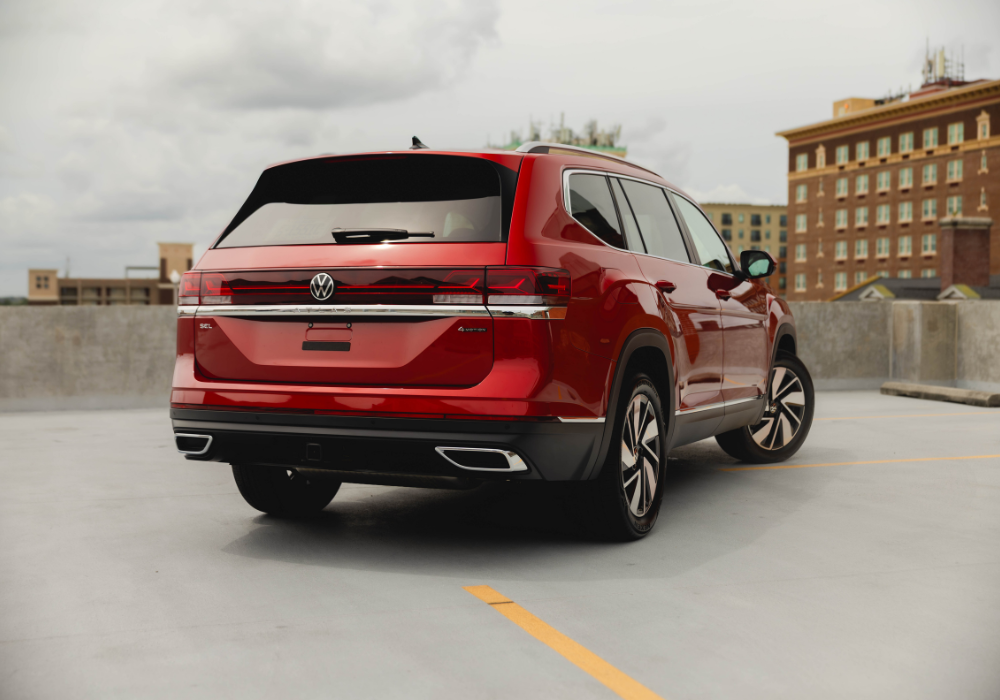 Exterior rear of the new Volkswagen Atlas parked on top of a parking garage.