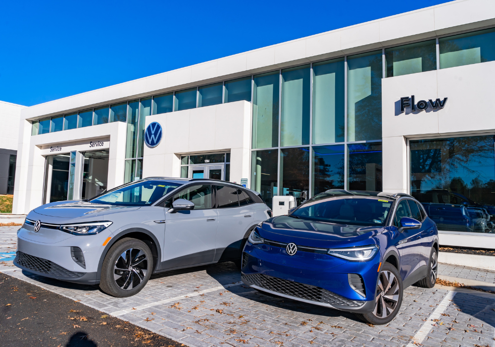 Two fuel efficient Volkswagen cars parked outside of the Flow Volkswagen of Charlottesville dealership