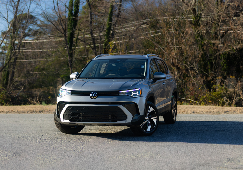 2026 Volkswagen Taos parked on a paved surface with trees in the background.